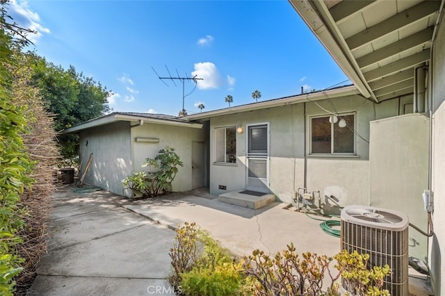 entrance to property with central AC and a patio area