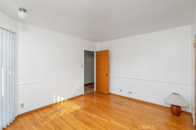 unfurnished room with hardwood / wood-style flooring