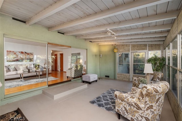 sitting room featuring wood ceiling and beam ceiling