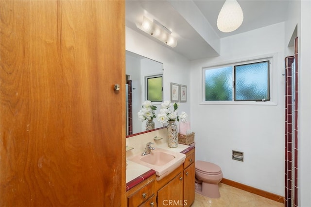 bathroom featuring vanity, toilet, and tile patterned flooring