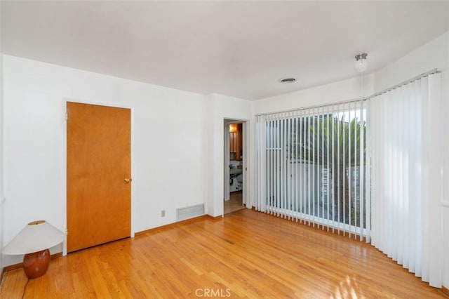 empty room with hardwood / wood-style flooring