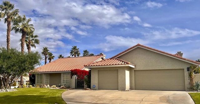 view of front of home with a garage and a front lawn