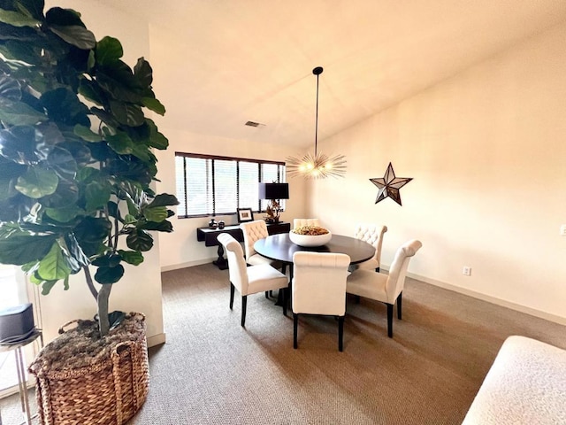 dining space featuring carpet floors and an inviting chandelier