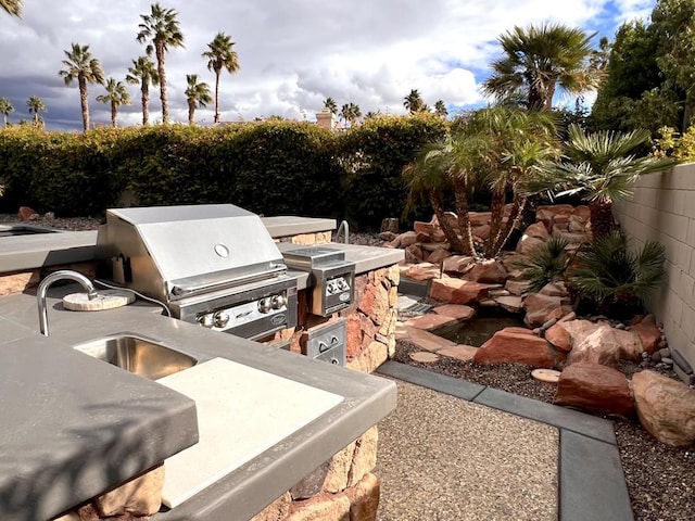 view of patio featuring area for grilling, sink, and grilling area