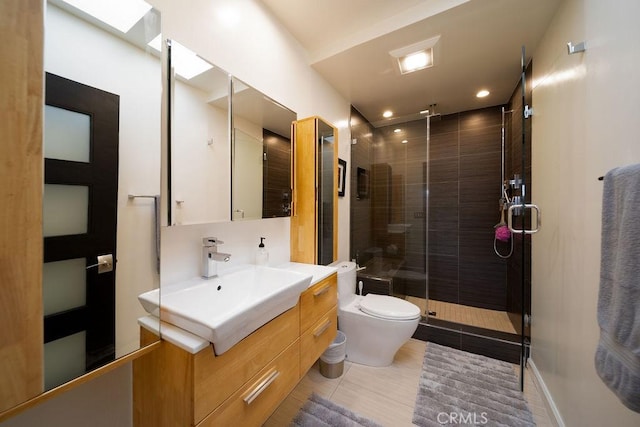 bathroom featuring vanity, tile patterned floors, toilet, and walk in shower