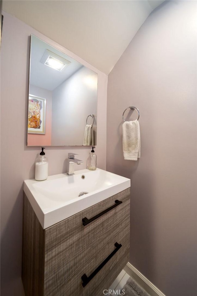 bathroom featuring vanity and vaulted ceiling