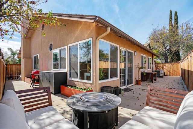 back of property featuring outdoor lounge area and a patio