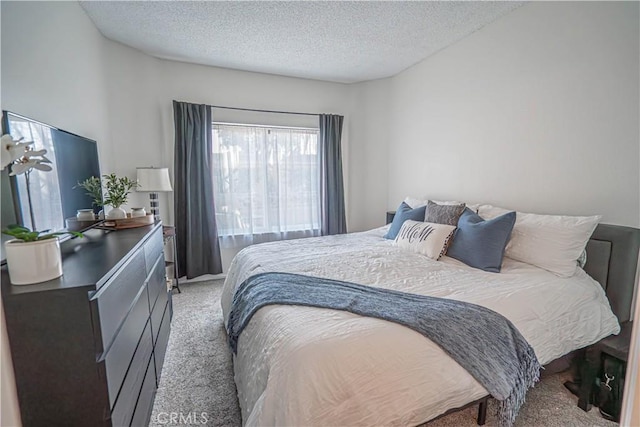 carpeted bedroom with a textured ceiling