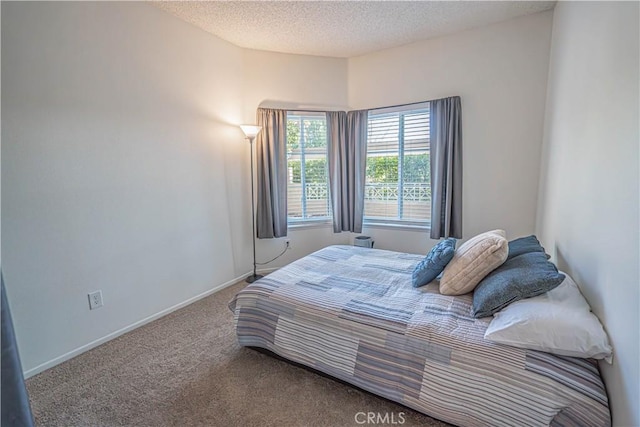 carpeted bedroom with a textured ceiling