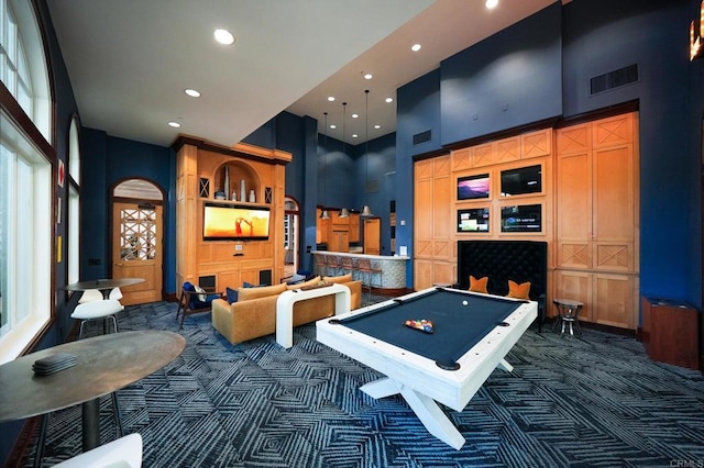 recreation room with pool table, dark carpet, and a high ceiling