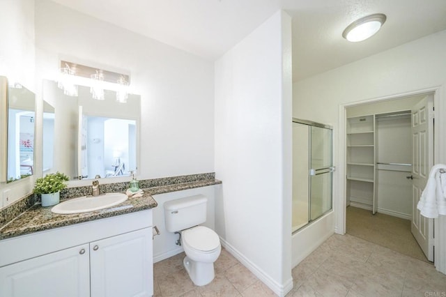 full bathroom with vanity, shower / bath combination with glass door, and toilet