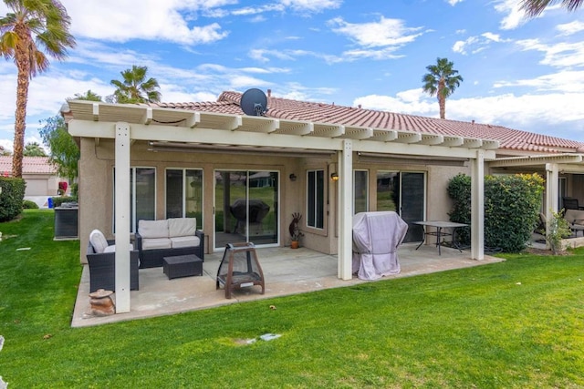 rear view of property featuring outdoor lounge area, a patio area, and a lawn