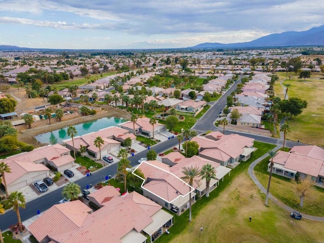 drone / aerial view featuring a water and mountain view