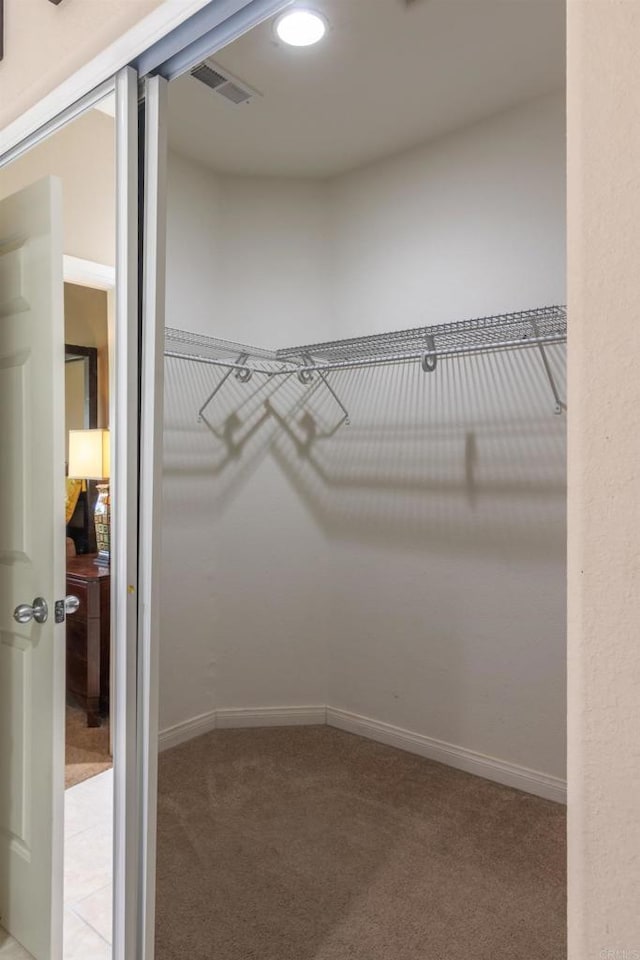 walk in closet featuring carpet floors