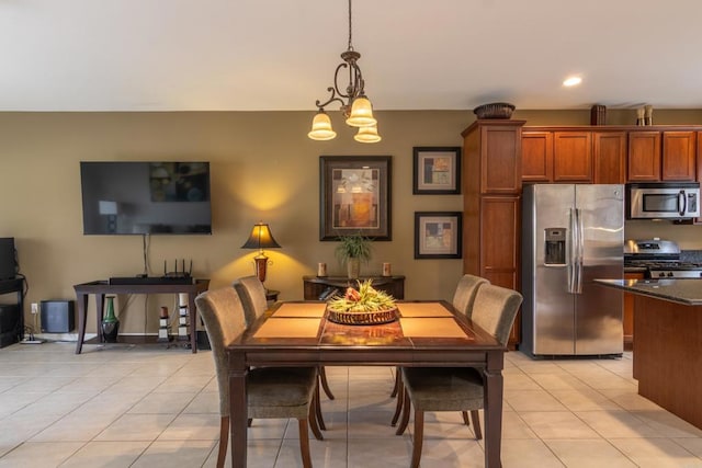 dining room with a chandelier and light tile patterned flooring