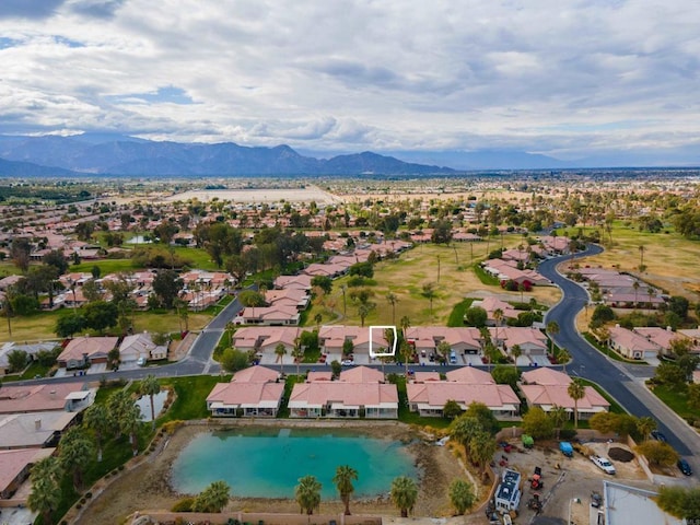 birds eye view of property with a water and mountain view