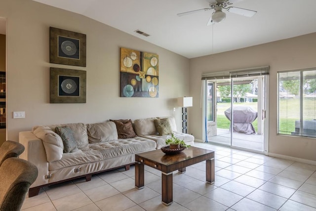 living room with ceiling fan, lofted ceiling, light tile patterned floors, and plenty of natural light