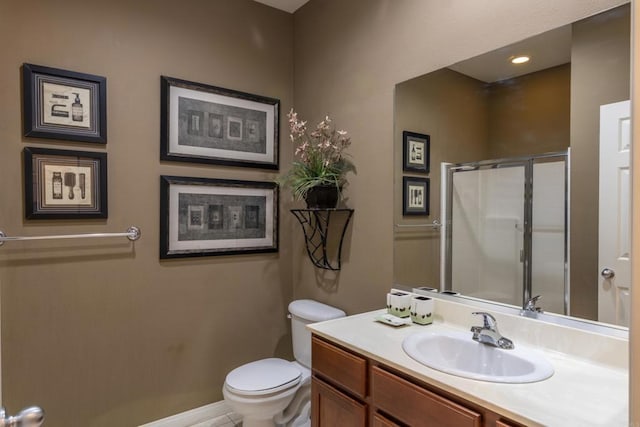 bathroom with vanity, toilet, and an enclosed shower