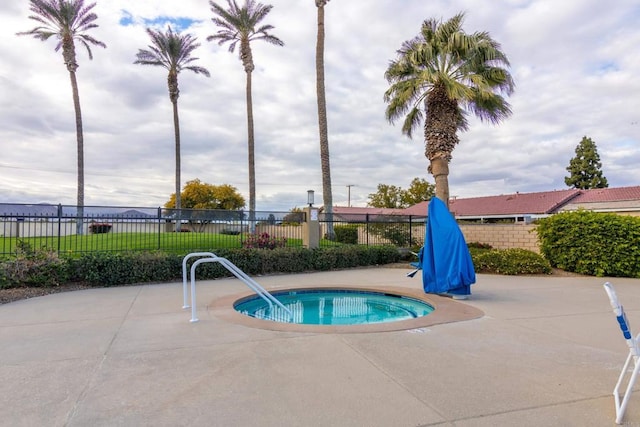 view of pool featuring a hot tub and a patio