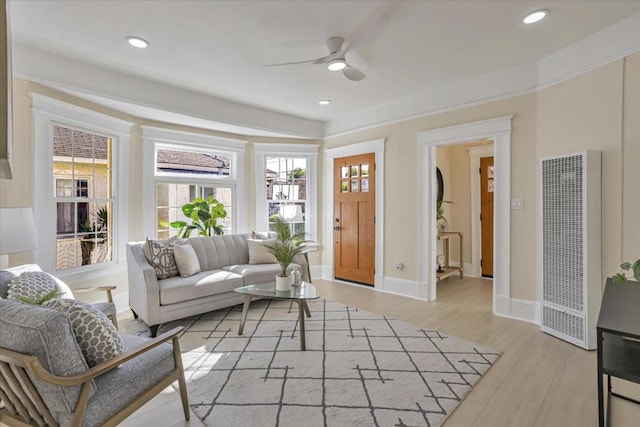 living room featuring ceiling fan and light hardwood / wood-style floors