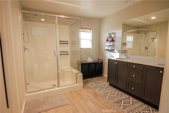 bathroom with vanity, hardwood / wood-style floors, and walk in shower