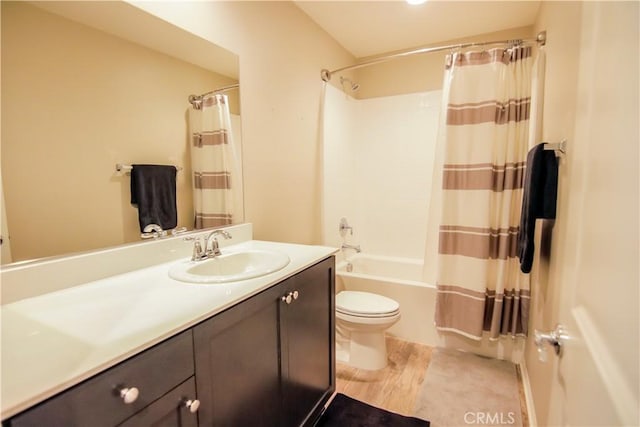 full bathroom featuring shower / tub combo, vanity, hardwood / wood-style flooring, and toilet