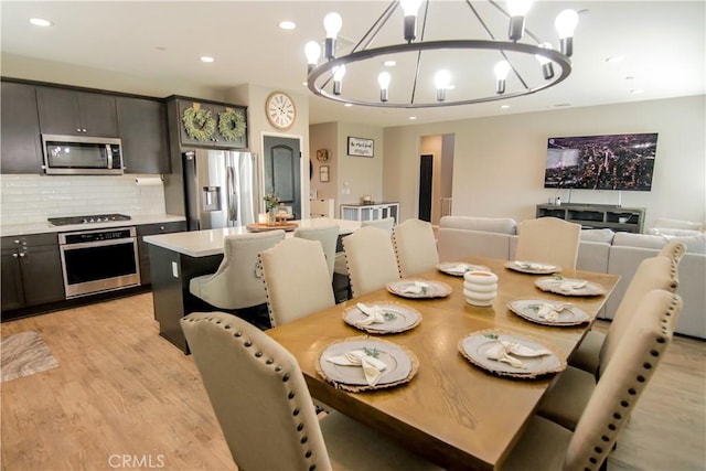 dining space featuring a notable chandelier and light hardwood / wood-style flooring