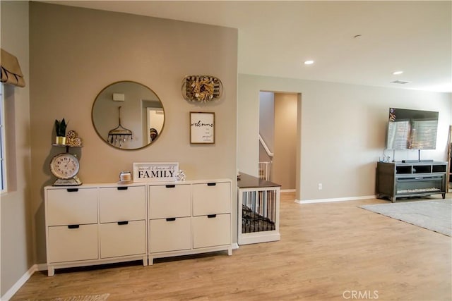 hallway with light hardwood / wood-style floors