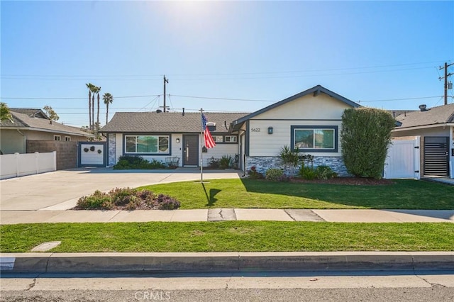 ranch-style home with a garage and a front lawn