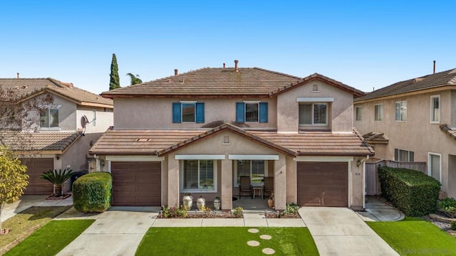 view of front of home featuring a garage and a front lawn