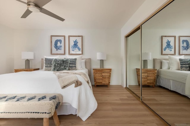 bedroom with hardwood / wood-style floors, a closet, and ceiling fan