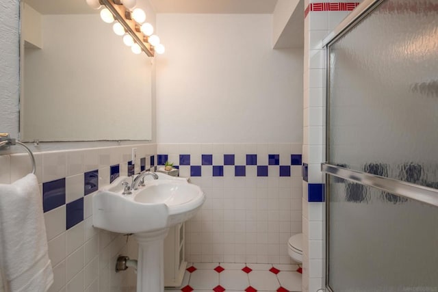 bathroom featuring tile walls, tile patterned flooring, toilet, and walk in shower