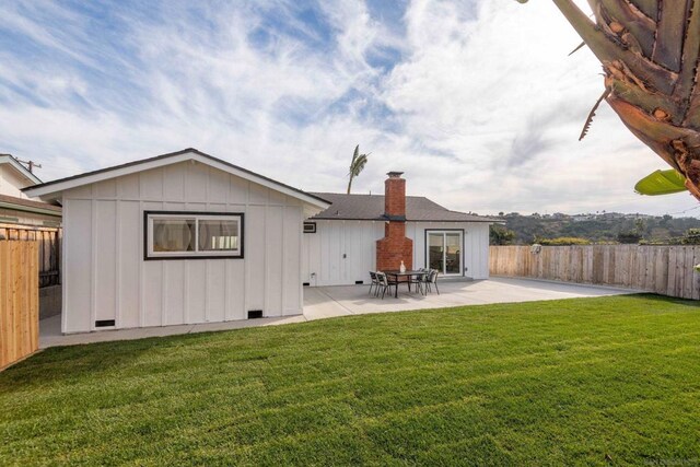 back of property featuring a patio and a lawn