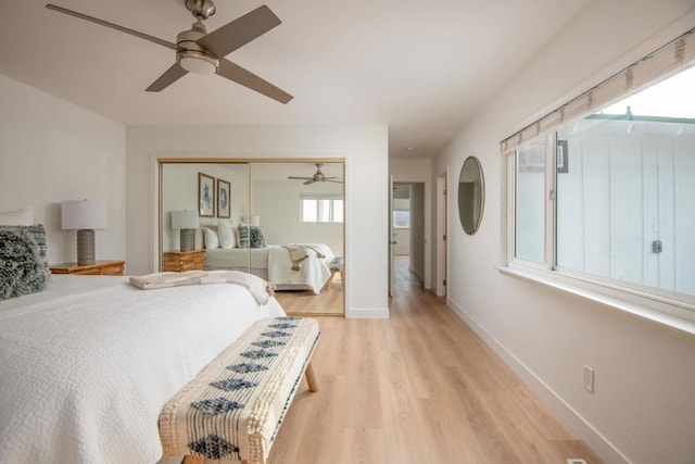 bedroom featuring ceiling fan, a closet, and light hardwood / wood-style flooring