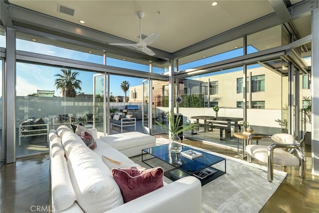 sunroom featuring ceiling fan