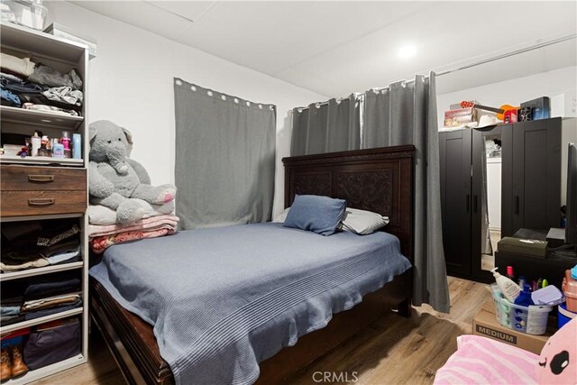 bedroom with hardwood / wood-style flooring