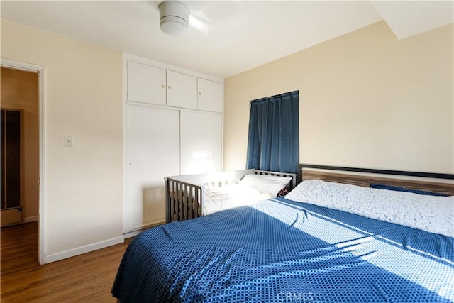 bedroom featuring hardwood / wood-style floors and a closet