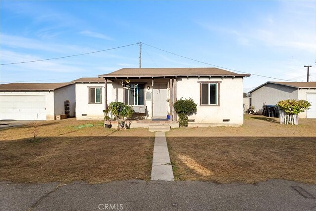 ranch-style home featuring a garage and a front lawn