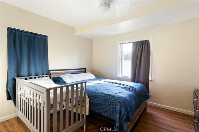 bedroom featuring dark wood-type flooring