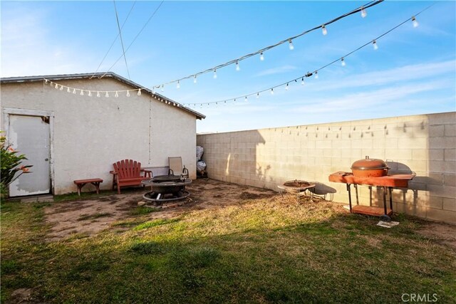 view of yard with a fire pit