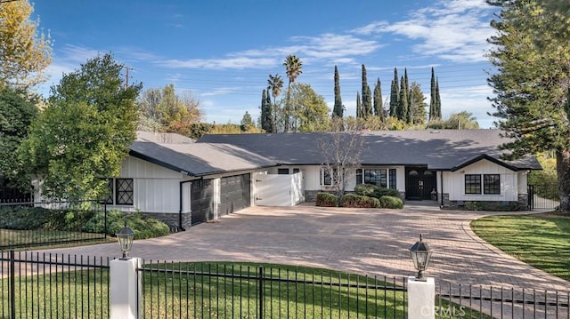 ranch-style house featuring a garage and a front yard