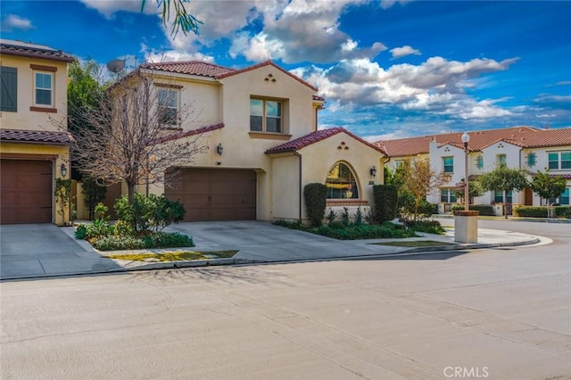 mediterranean / spanish-style house with a garage