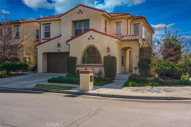 mediterranean / spanish-style home with a garage