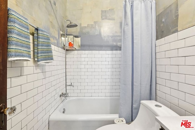 bathroom featuring tile walls, toilet, and shower / bath combo