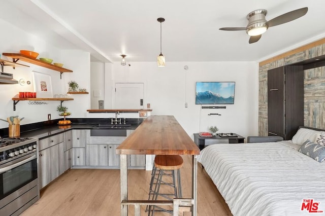 bedroom featuring sink and light hardwood / wood-style flooring