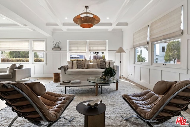 living room featuring beamed ceiling, coffered ceiling, and light hardwood / wood-style floors