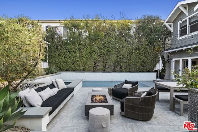 view of patio / terrace featuring an outdoor living space with a fire pit