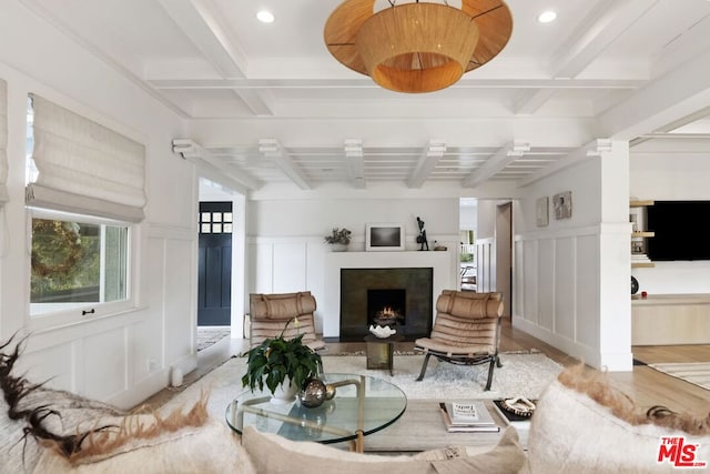 living room with beamed ceiling and coffered ceiling