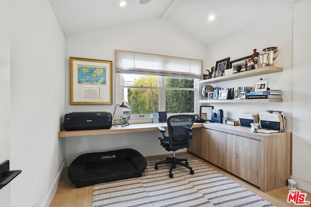 office with light hardwood / wood-style flooring and vaulted ceiling