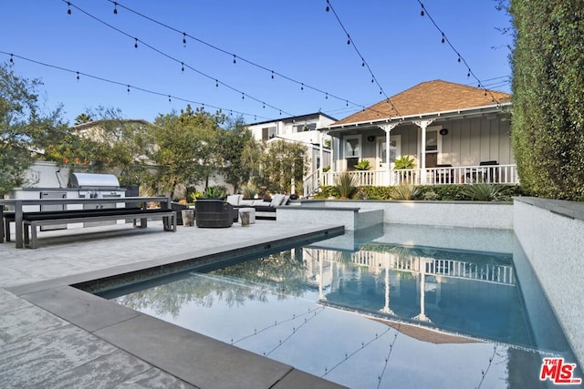 view of swimming pool featuring a patio area